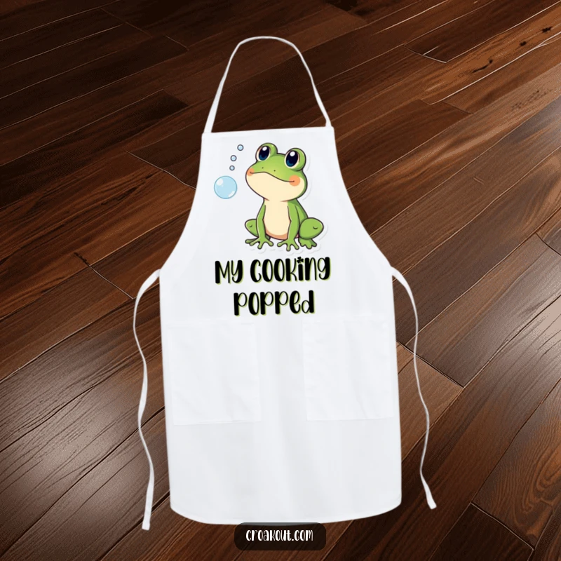 Funny apron showing a frog character shocked by a popping bubble, adding humor to kitchen tasks.