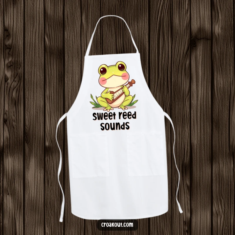 Funny apron with a charming frog character playing a miniature reed instrument, ideal for kitchen protection and adding a touch of musical whimsy.
