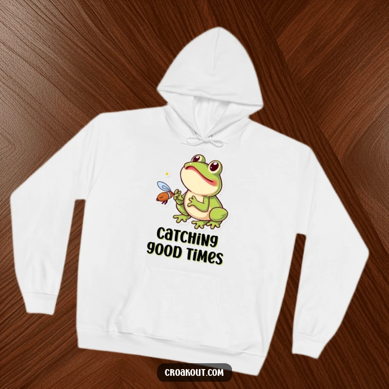 Funny frog hoodie depicting a small amphibian with its tongue extended, excitedly catching a fly, a humorous and cuddly design.