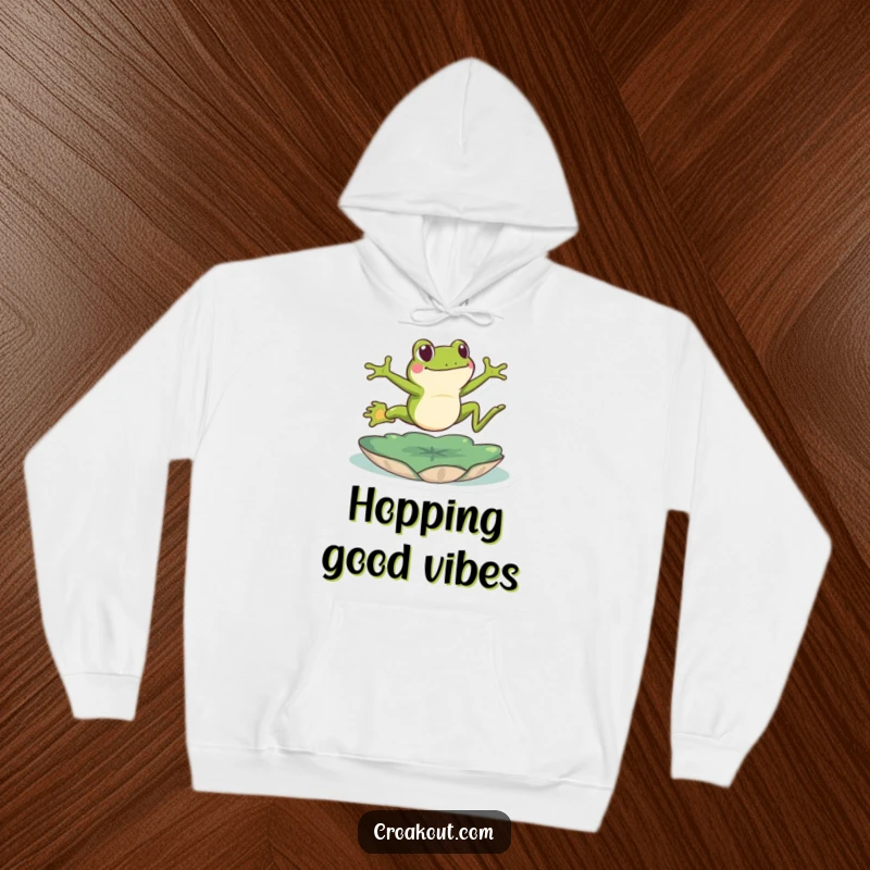 Funny frog hoodie depicting a green amphibian energetically leaping over a lily pad, a spirited and humorous design for cozy wear.