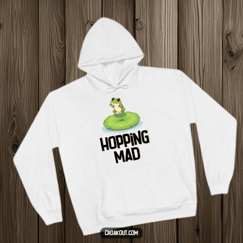 Funny hoodie depicting a tiny, happy frog character leaping towards a large lily pad, perfect for relaxed, whimsical wear.