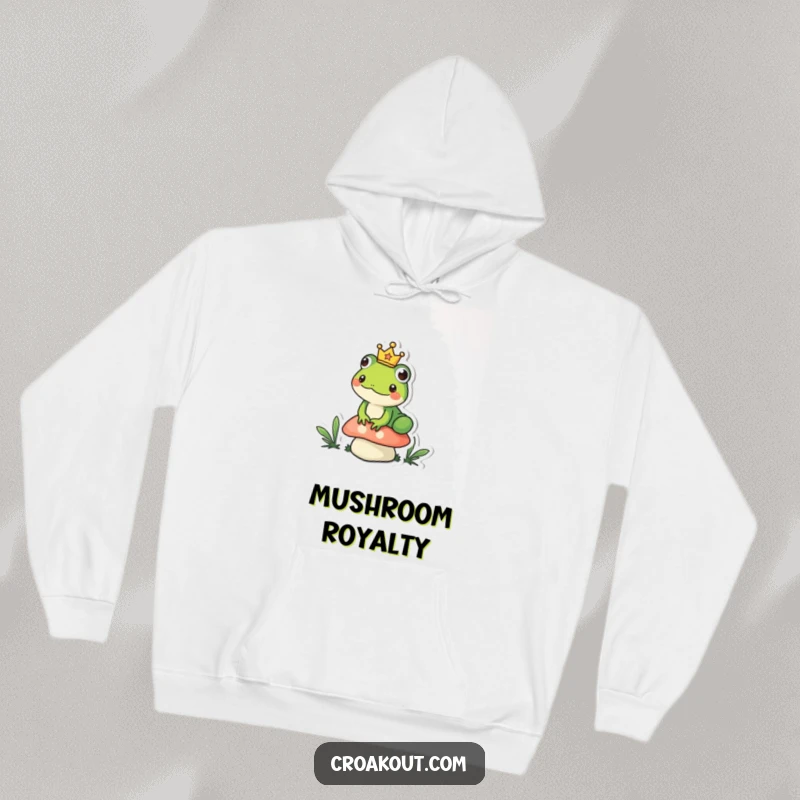 Funny frog hoodie depicting a small amphibian wearing a tiny crown, sitting regally on a mushroom, a cozy and humorous royal design.