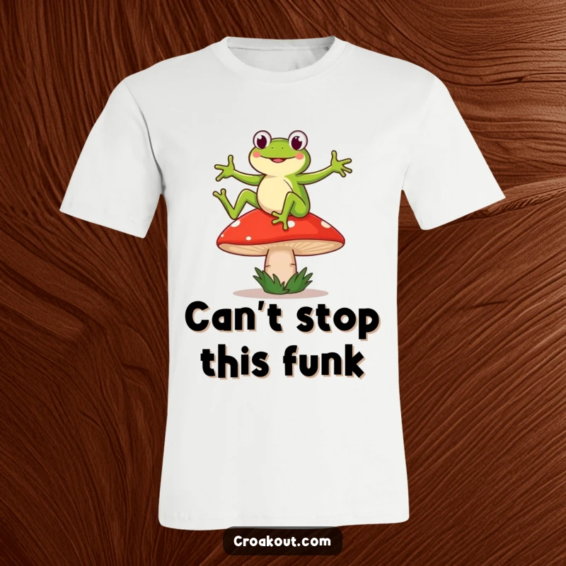 Funny t-shirt of a frog character doing a silly, energetic dance on a wobbly mushroom, full of humorous delight.