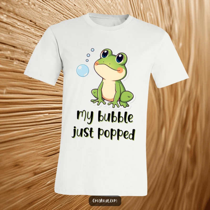 Funny t-shirt of a frog character looking shocked and surprised as a small bubble pops, conveying humorous astonishment.