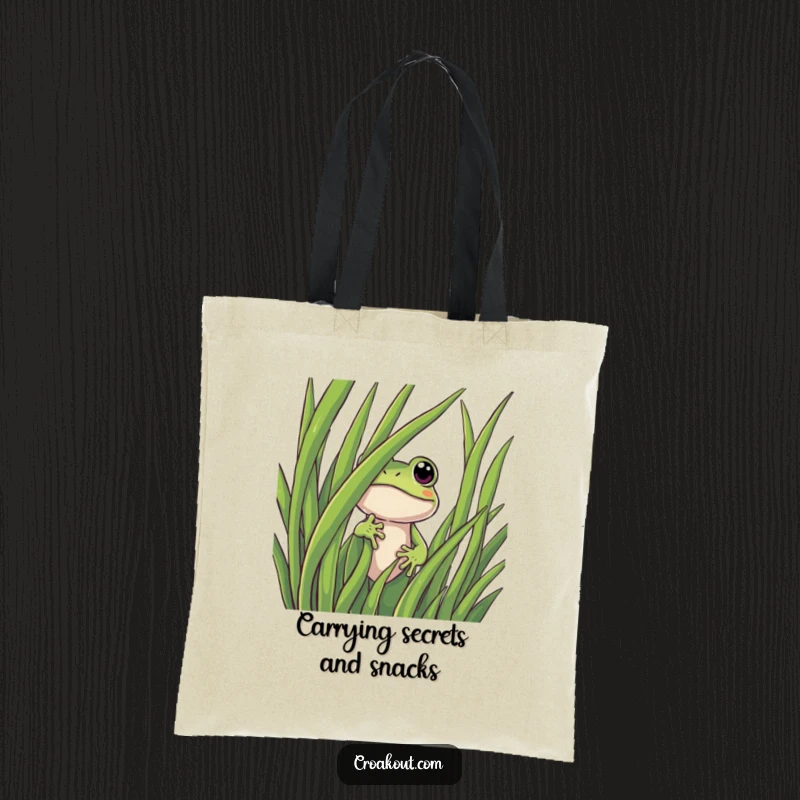 Funny frog tote bag showcasing a curious character peeking mischievously from behind a tall blade of grass, perfect for carrying treasures.