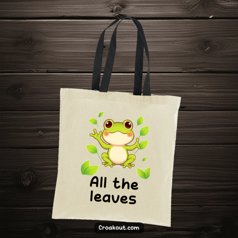 Funny kawaii frog tote bag showing a cute amphibian happily juggling bright green leaves, a charming and humorous carry-all.